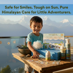 Happy child unboxing HimSoul Himalayan skincare kit against a mountain backdrop, showcasing safe and natural sun protection.