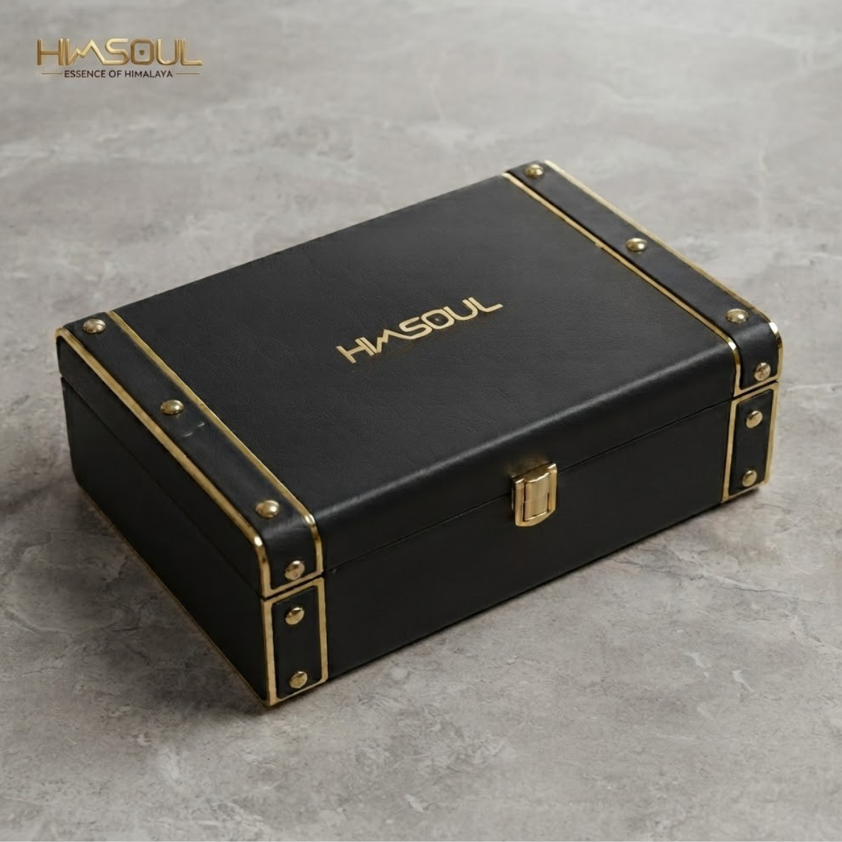 Himsoul black leatherette gift box featuring gold foil stamped logo, antique brass corner rivets, and metallic latch closure.