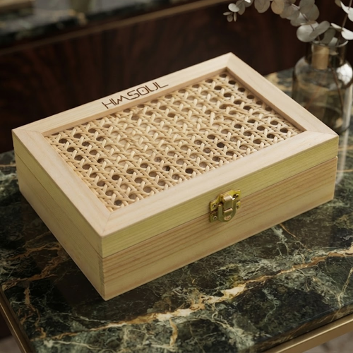 Himsoul luxury wooden gift box with handcrafted cane mesh lid and antique brass latch on a premium dark green marble surface.