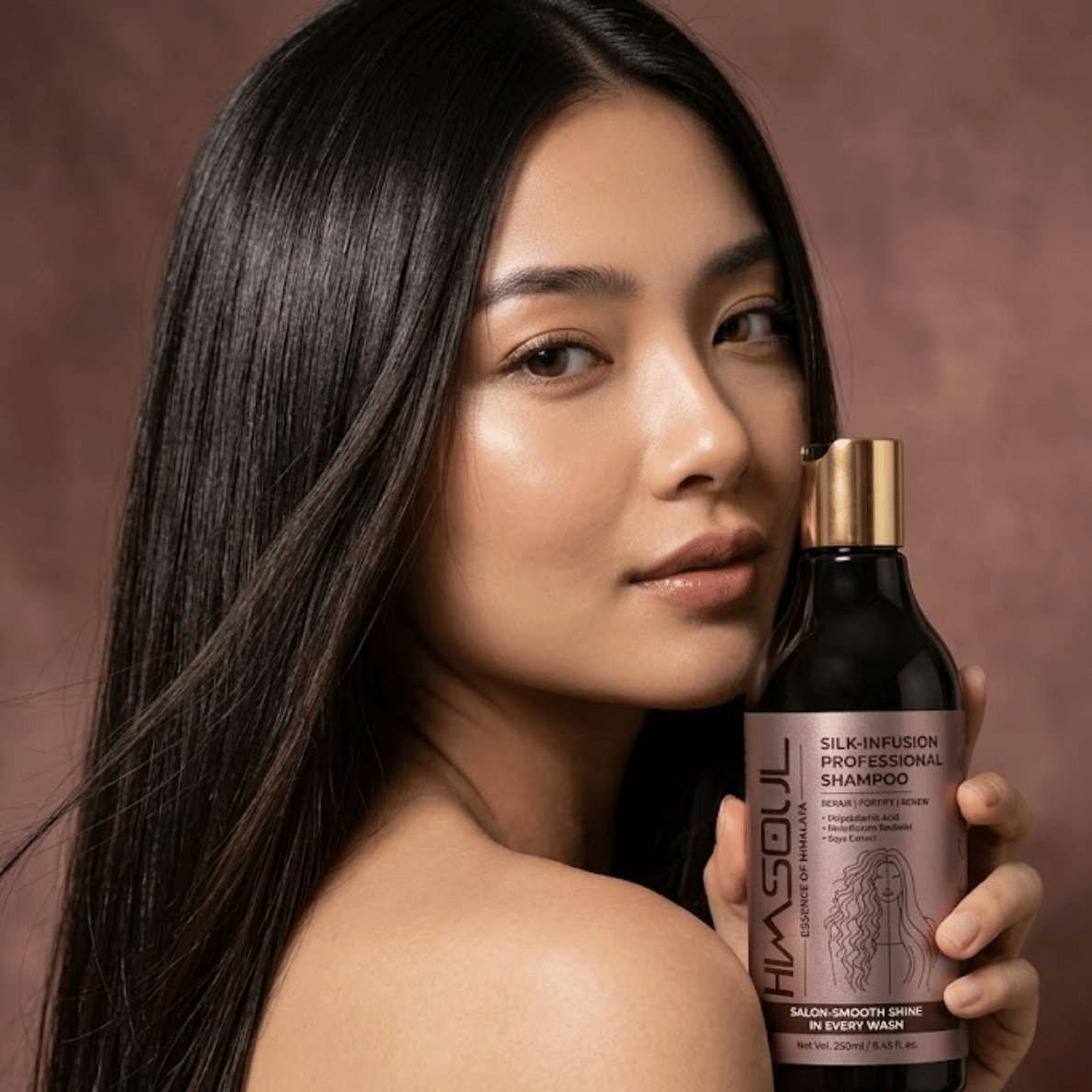 Woman showcasing shiny, frizz-free, salon-smooth hair while holding Himsoul Silk-Infusion Shampoo for deep hair repair and nourishment.