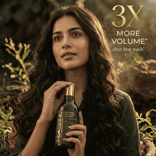 Woman showcasing thick, wavy, voluminous hair holding Himsoul Volumizing Shampoo, delivering 3X instant weightless bounce and root lift after the first wash.